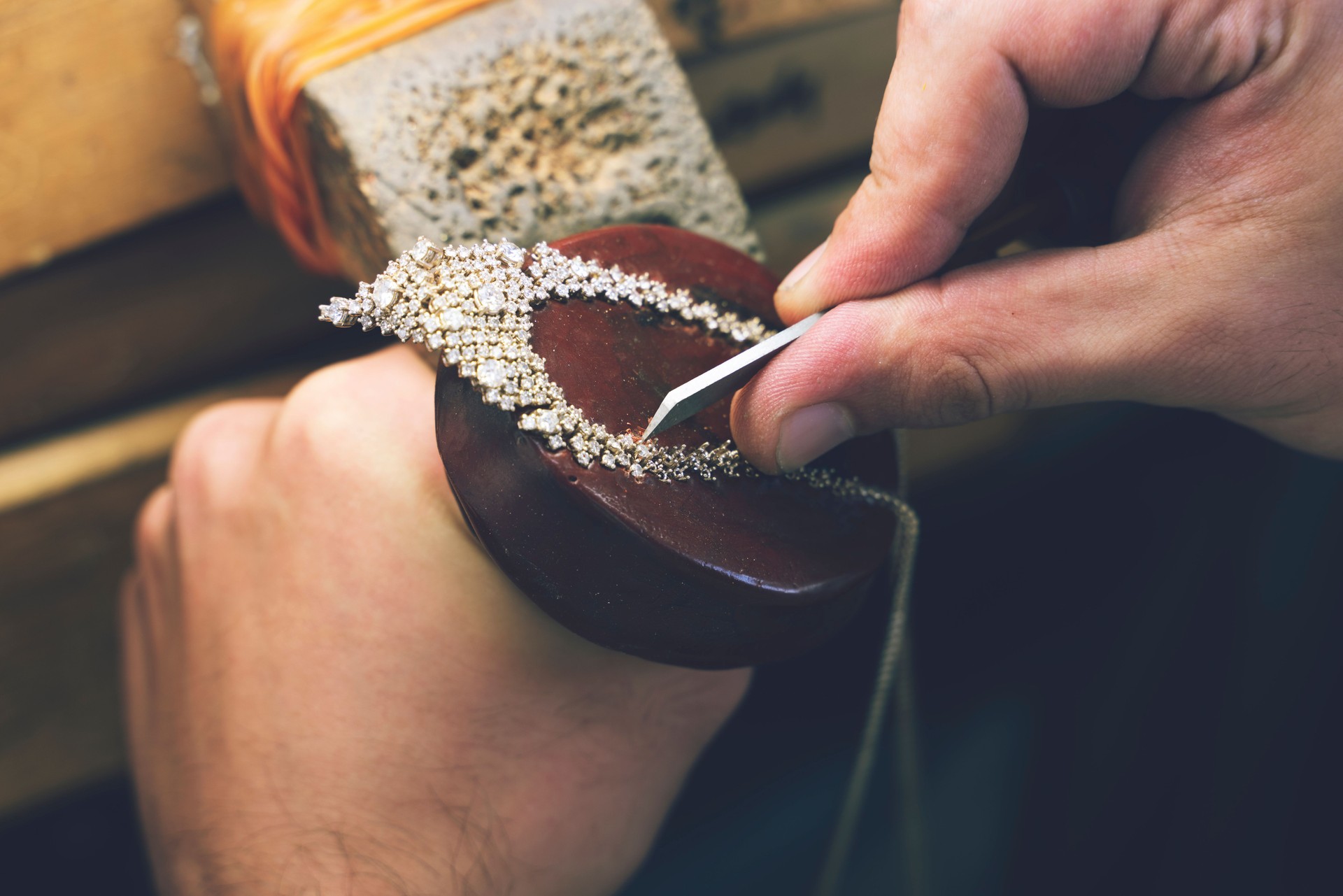 Jeweler making handmade jewelry on vintage bench. The art of jewelry. Jeweler making handmade necklace